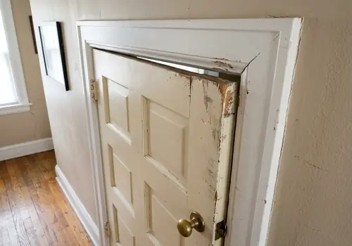 Sticking interior door frame misaligned from foundation shift
